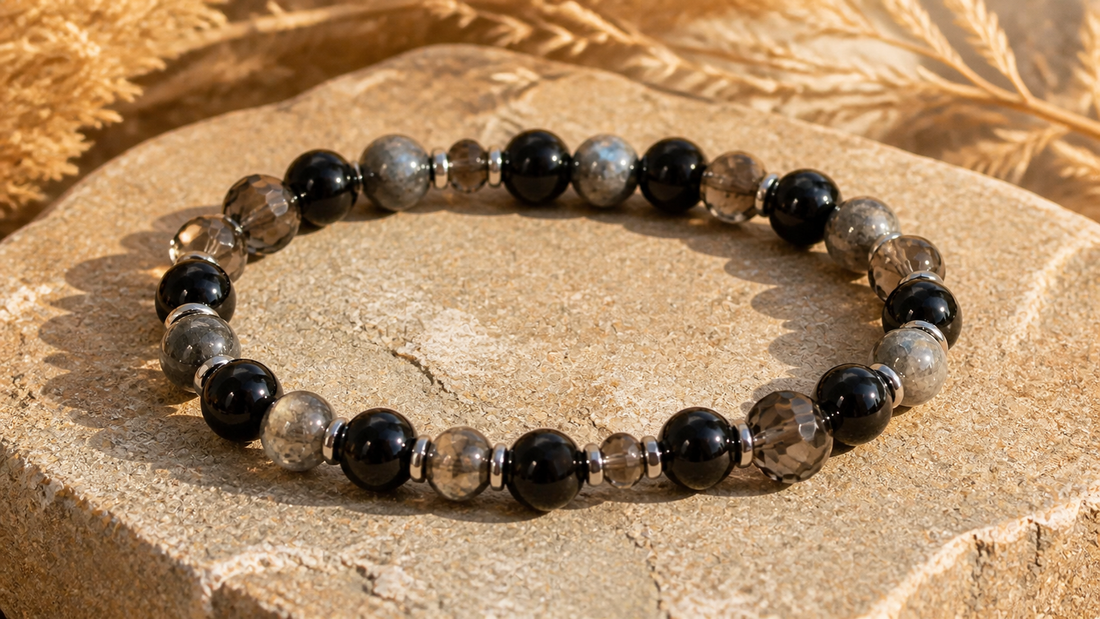 Black obsidian, silver sheen obsidian and smoky quartz bracelet on sunlit stone