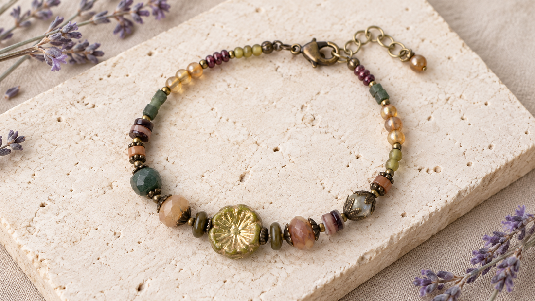Earth-tone boho crystal bracelet with antique brass details and an asymmetric floral focal bead