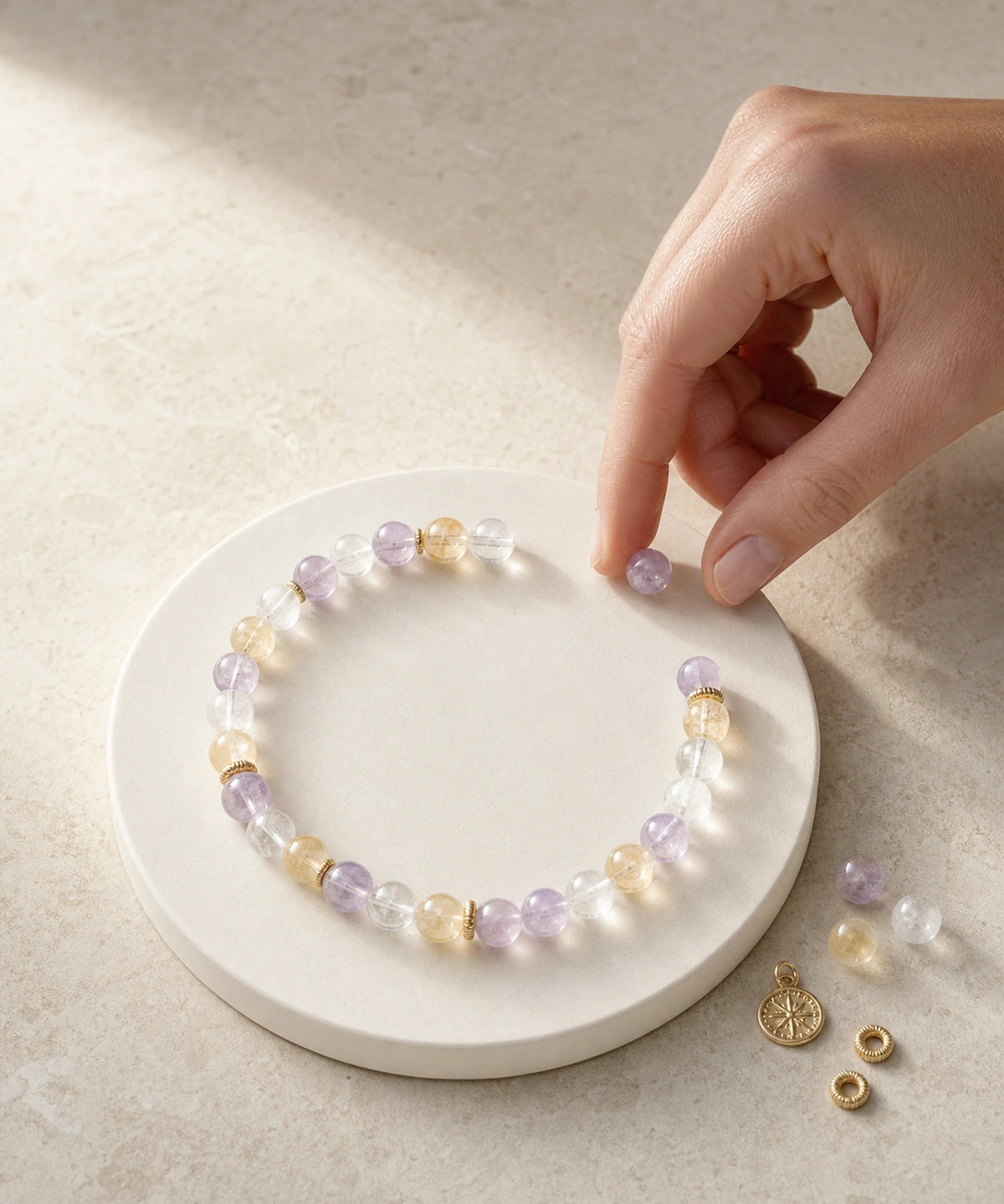 Customer arranging crystal beads and charms by hand
