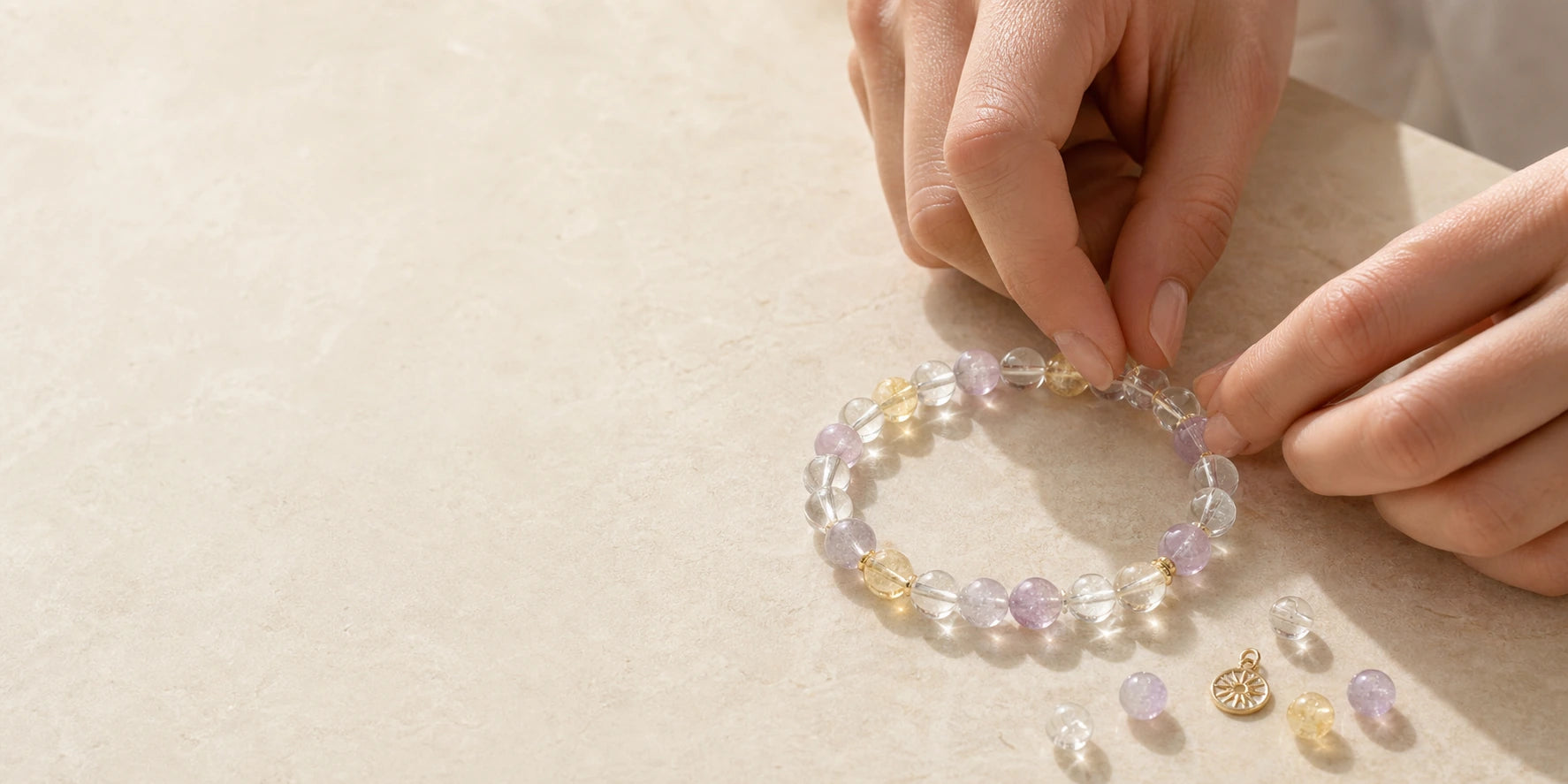 Hands gently arranging a finished custom crystal bracelet